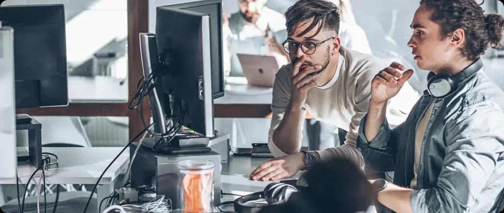Two engineers working together at a desk