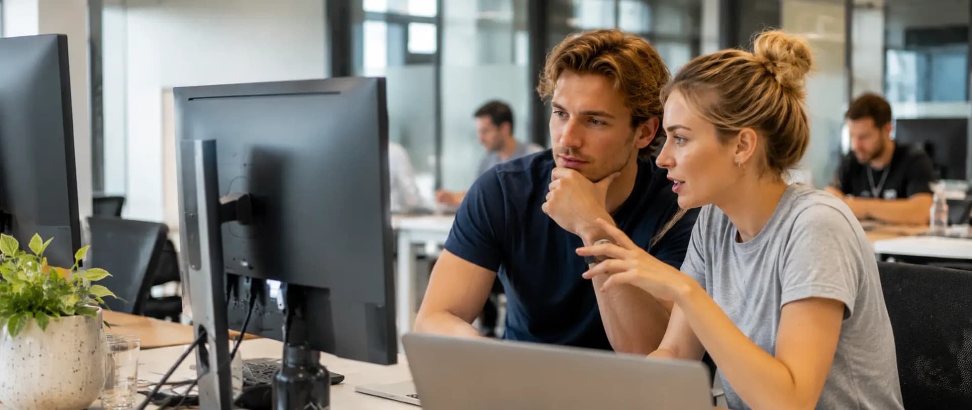 Two engineers reviewing work together at a desk